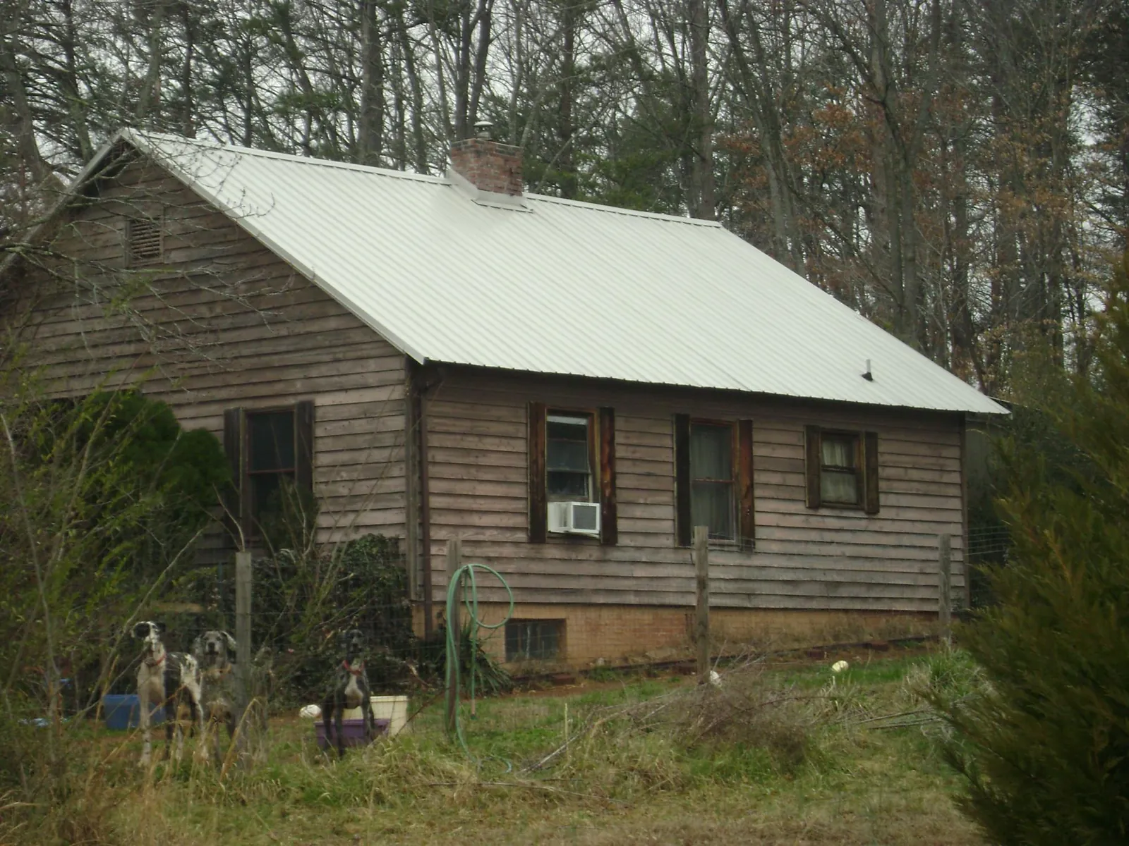 White metal roof on an old wood sided farmhouse, from a Metal Roof Installation job in Bellmawr